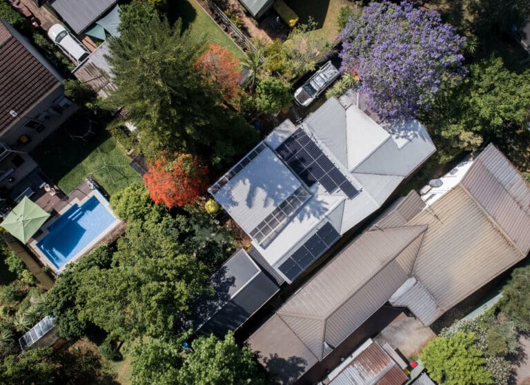 An aerial view of a house with solar panels.