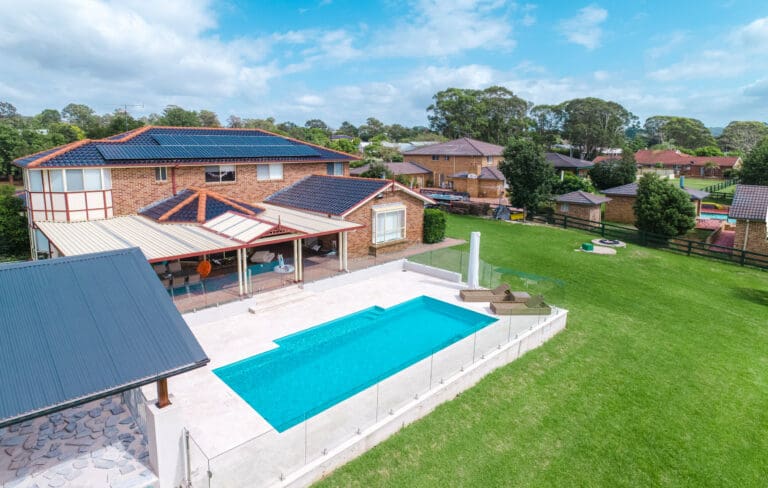 An aerial view of a house with a swimming pool.