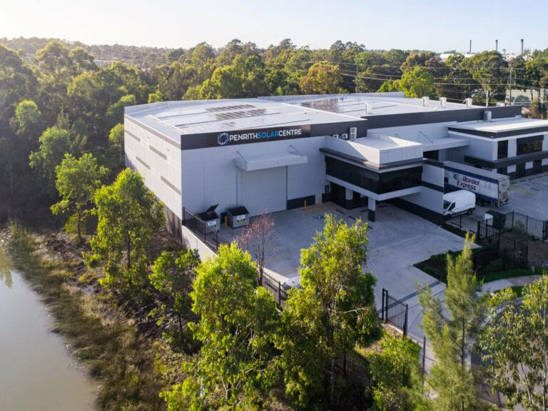An aerial view of an industrial building near a river.
