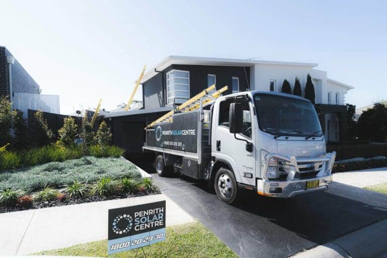 A truck is parked in front of a house.