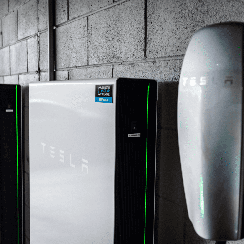 Two tesla chargers sitting next to each other.