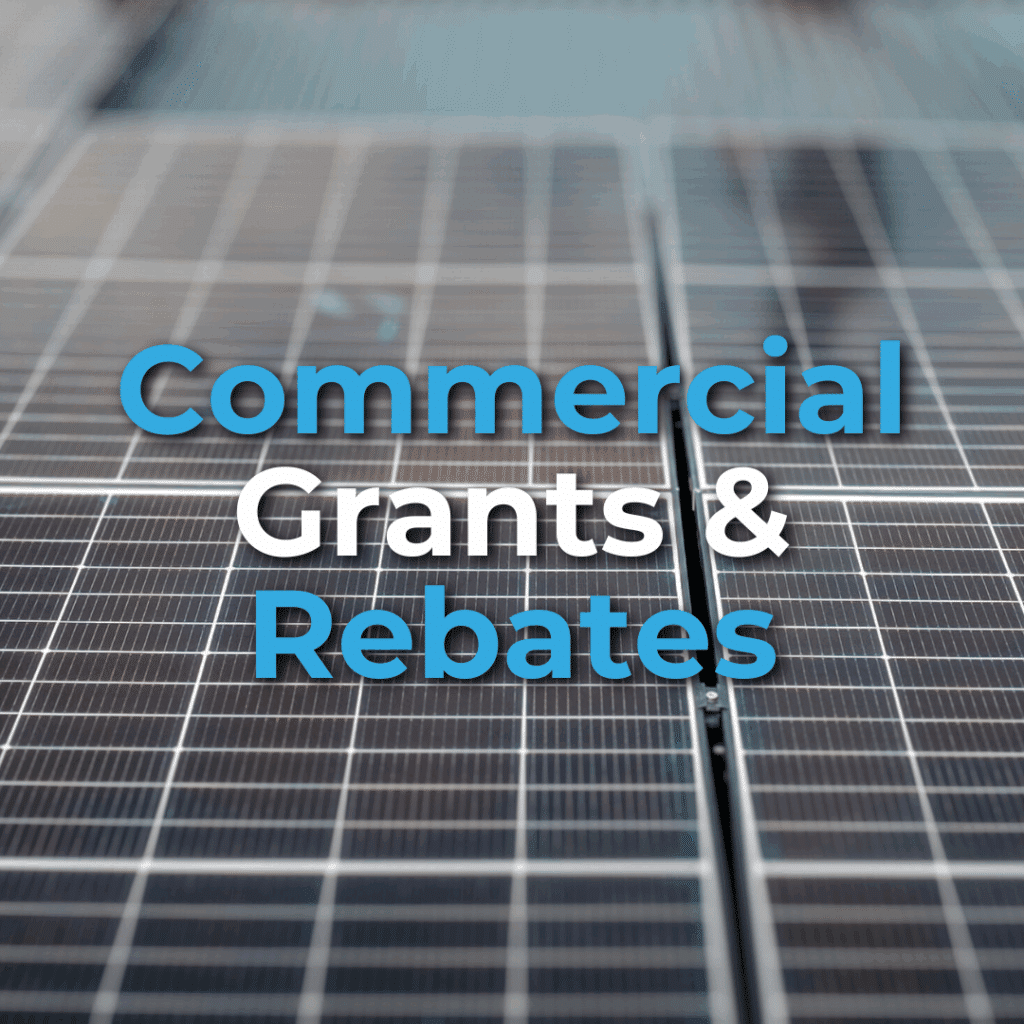 Close-up of solar panels with text overlay that reads "Commercial Grants & Rebates" in blue and white letters.