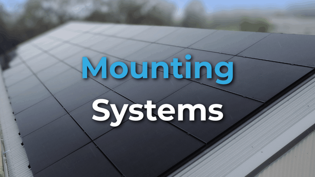 A row of black solar panels installed on a sloped rooftop with the words "Mounting Systems" overlaid in blue and white text.