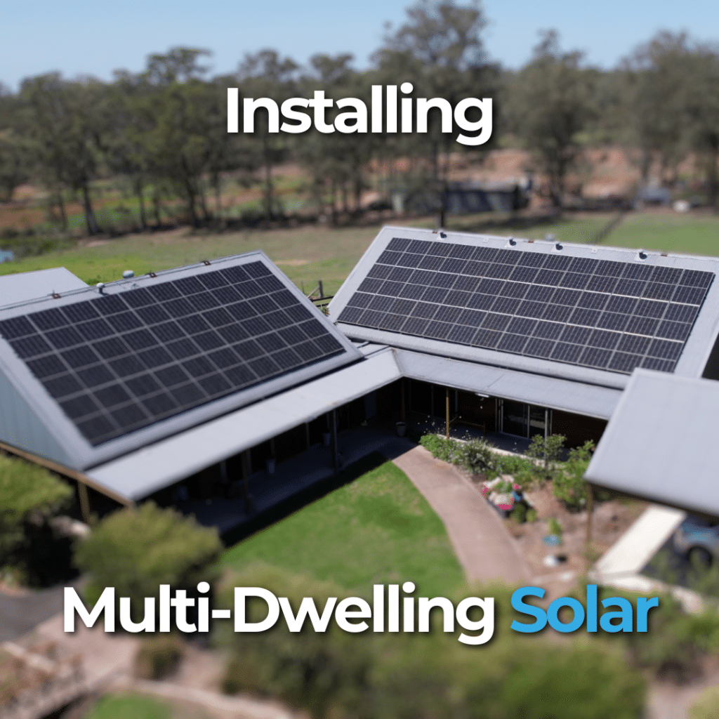 Aerial view of a multi-dwelling building with solar panels on the roof. Surrounding area includes trees and greenery. Text reads, "Installing Multi-Dwelling Solar.