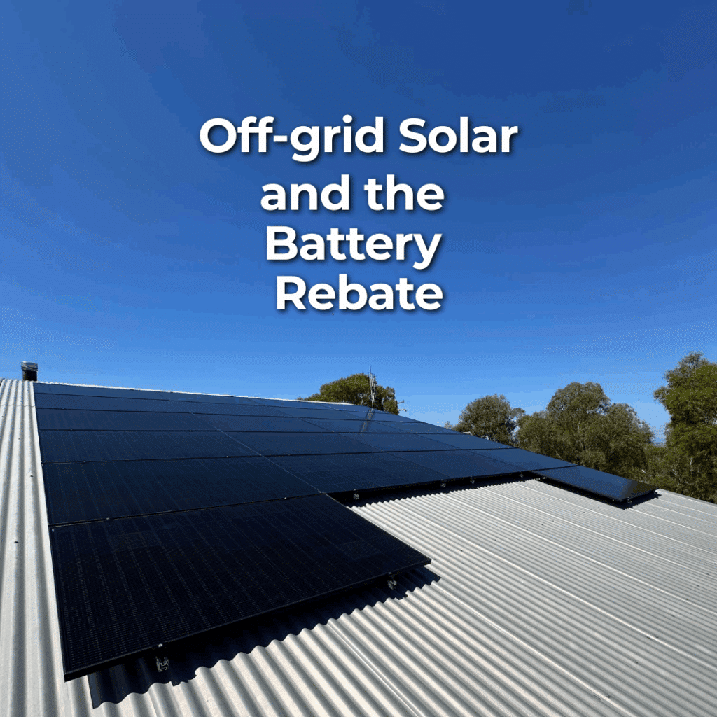 Solar panels installed on a metal roof with clear blue sky and trees in the background; text reads “Off-grid Solar and the Battery Rebate.”.