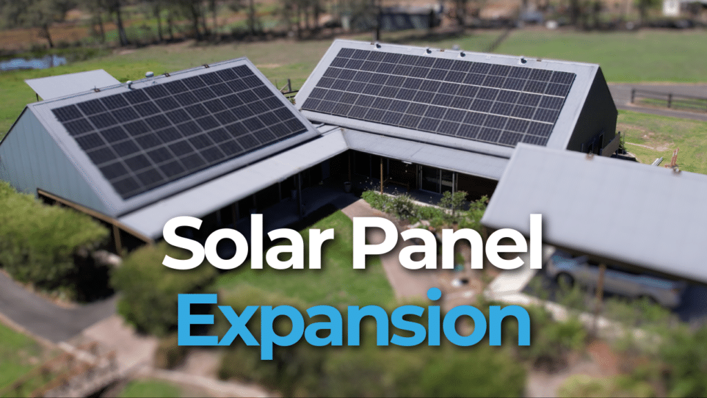 Aerial view of a house with solar panels on the roof, surrounded by greenery. Text overlay reads "Solar Panel Expansion.
