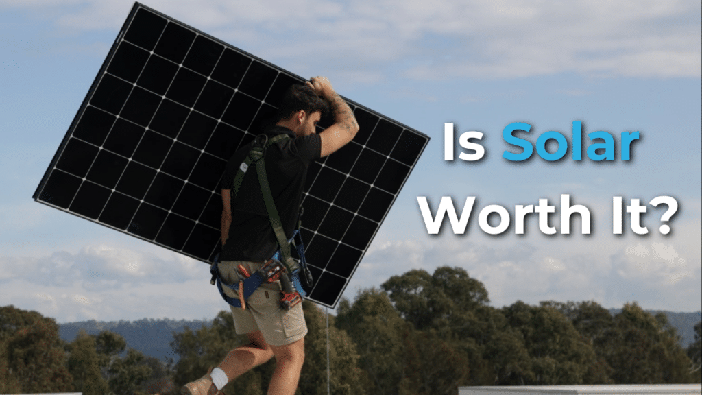 A person carrying a large solar panel on the shoulder, with text asking, "Is Solar Worth It?" in the foreground.