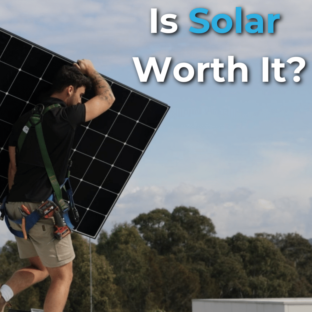 Person carrying a large solar panel on their shoulder against a backdrop of trees and blue sky. Text reads, "Is Solar Worth It?.