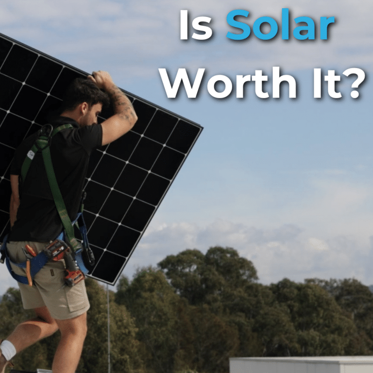 Person carrying a large solar panel on their shoulder against a backdrop of trees and blue sky. Text reads, "Is Solar Worth It?.